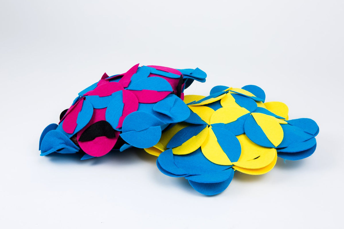 9. Close-up of blue and pink felt pieces stacked on a white background