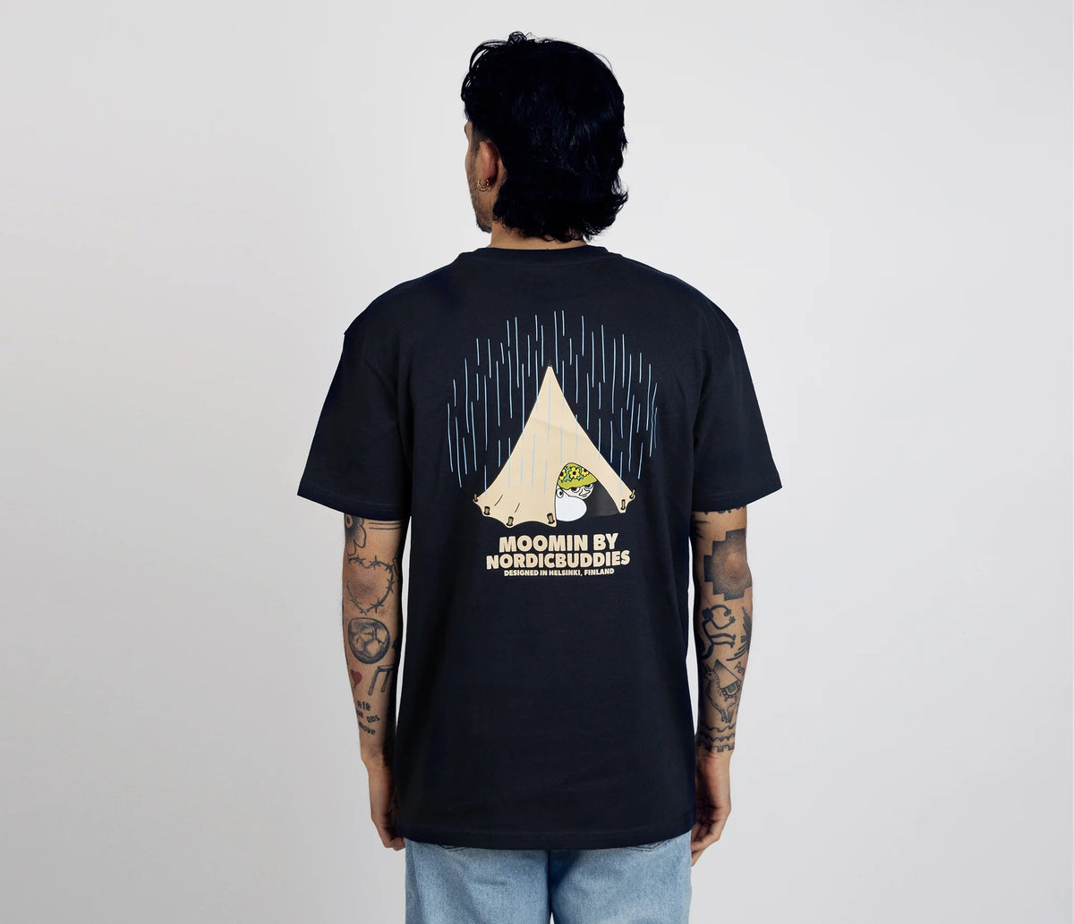2. Male model wearing unisex navy Moomin Adventure T-Shirt by NordicBuddies, back view showing tent design