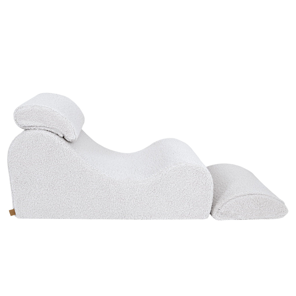 5. Side view of White Wave Lounger with extended footrest, highlighting its ergonomic S-shape in a studio setting