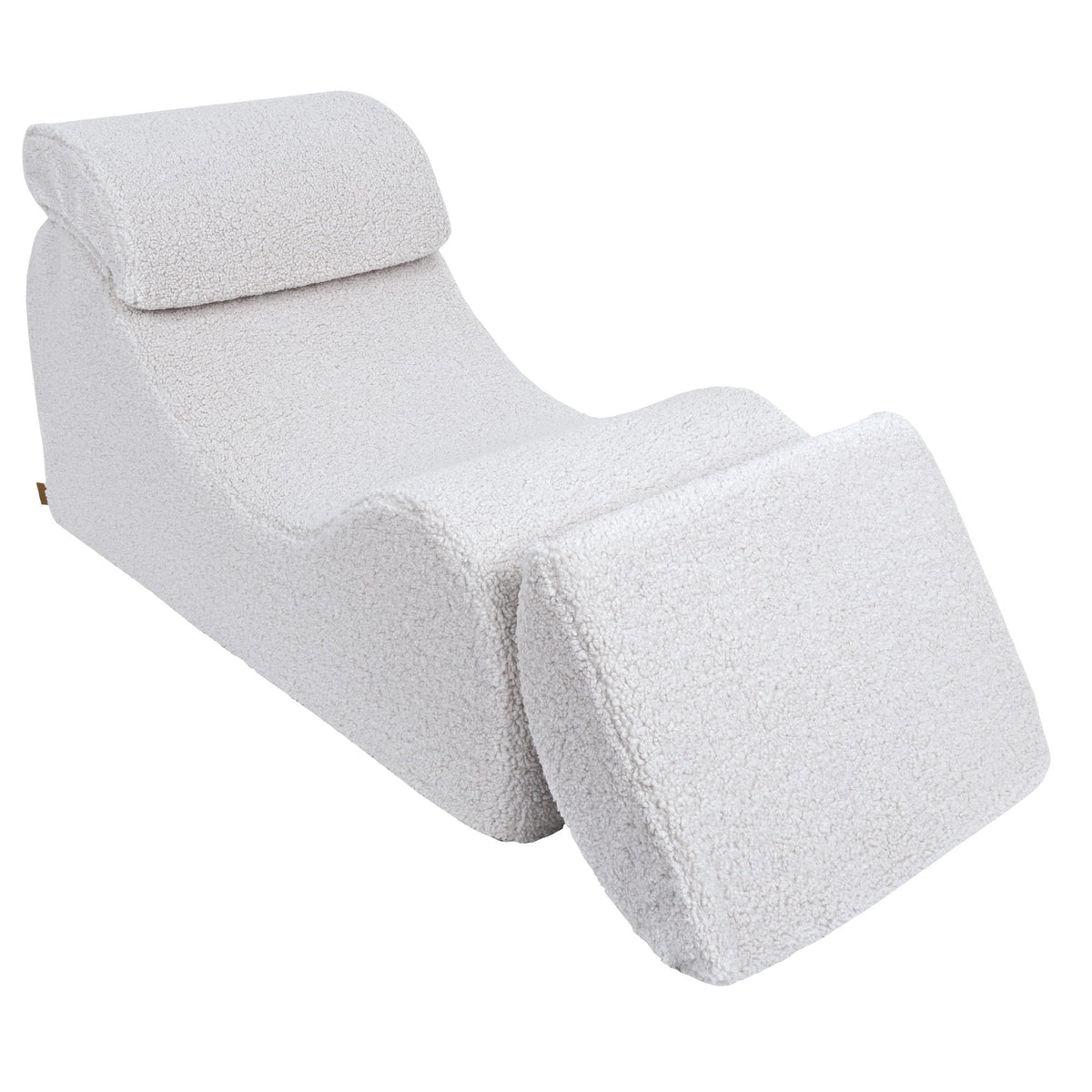 4. White Wave Lounger with fully extended footrest, emphasizing comfort and adjustability in a studio setting