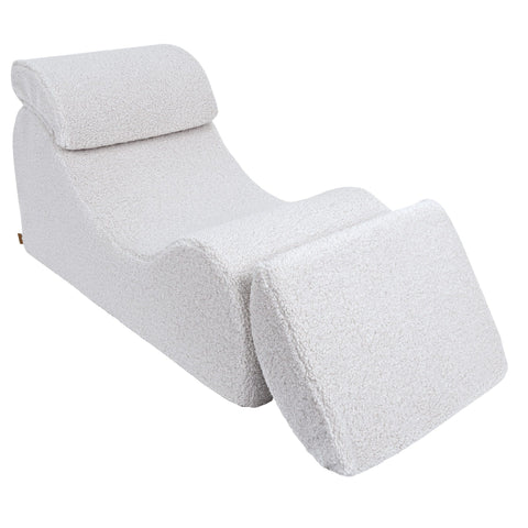 4. White Wave Lounger with fully extended footrest, emphasizing comfort and adjustability in a studio setting
