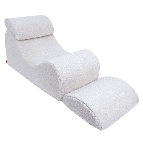 2. White Wave Lounger with extended footrest, highlighting its adjustable feature in a studio setting