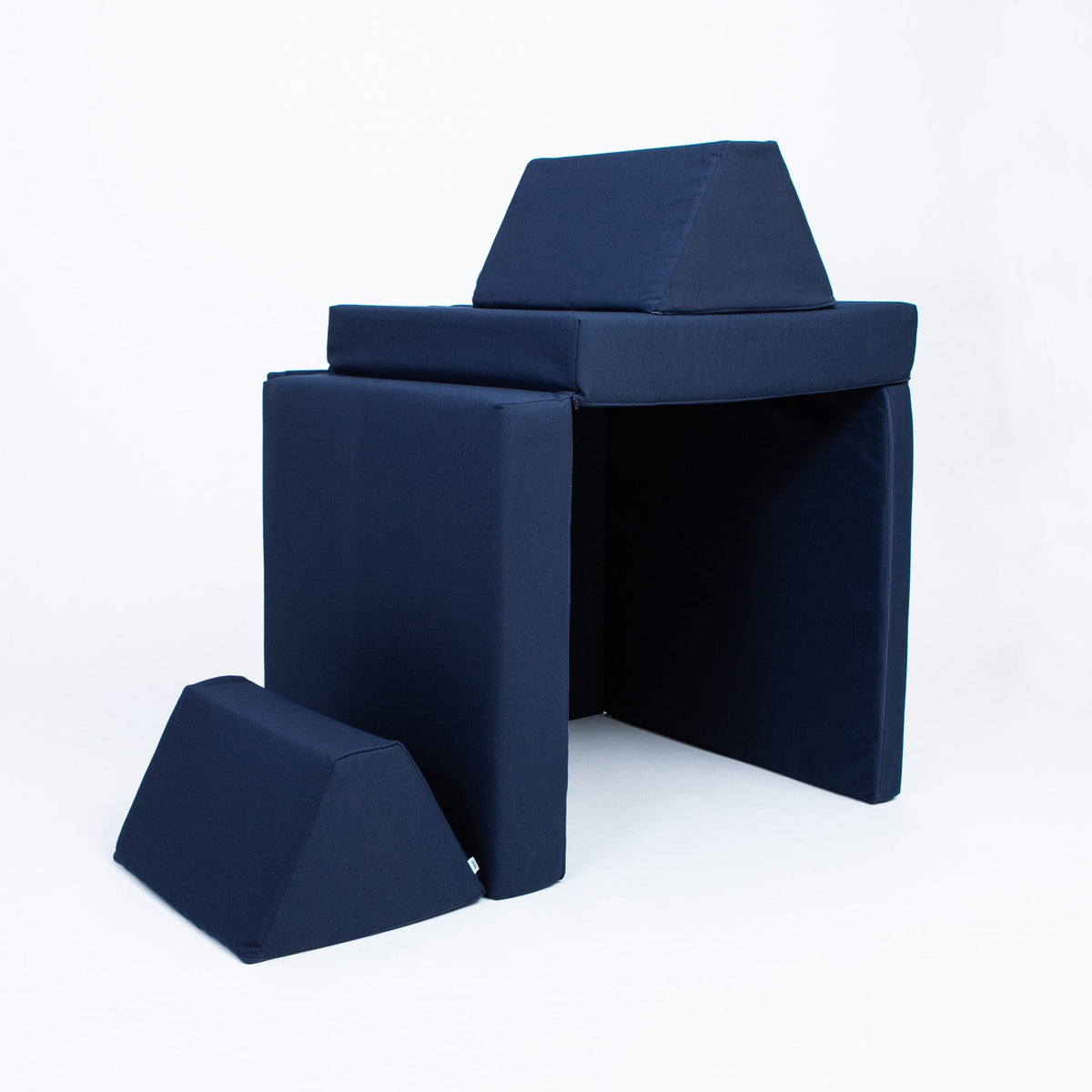2. Navy blue play mattress set configured as a fort with trapezoidal pillows on a white background