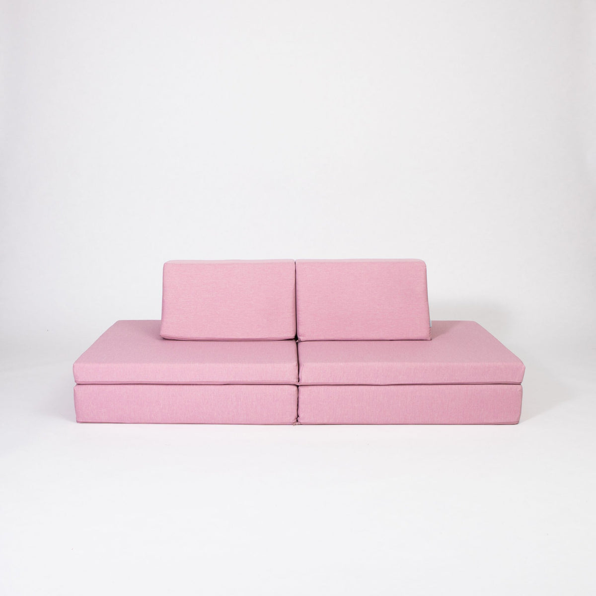 2. Pink activity play mattress set with two trapezoidal pillows on a white background