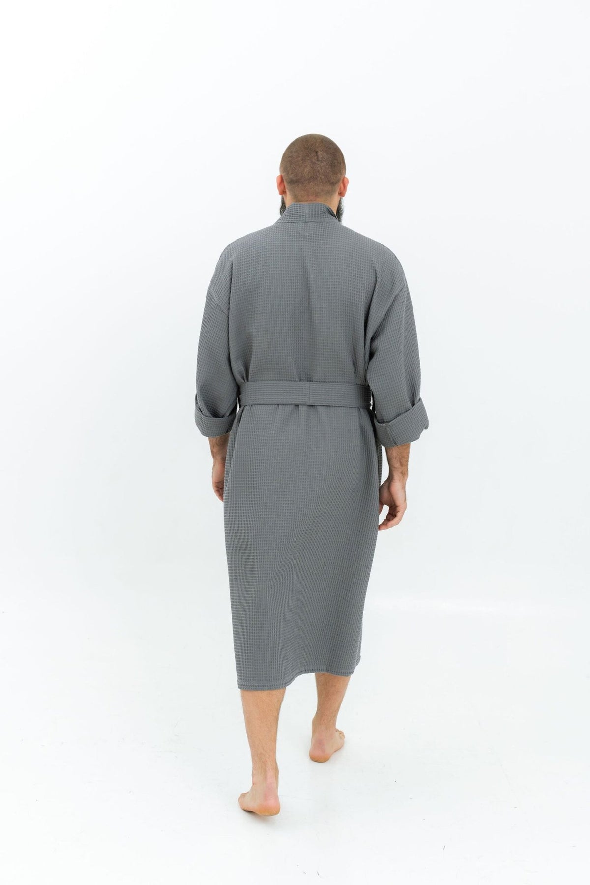 9. Man wearing grey waffle fabric robe with belt shown from back on white background