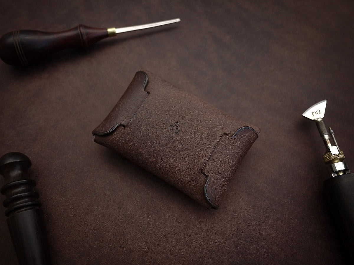 3. Back view of Mirgoods dark brown button leather wallet, highlighting one-piece folded design