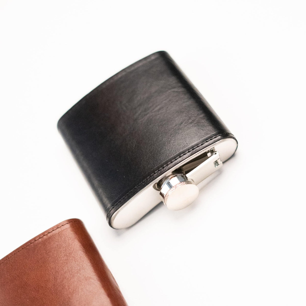 3. Close-up of Papillon Hip Flask No. 21 in black leather, highlighting stainless steel cap