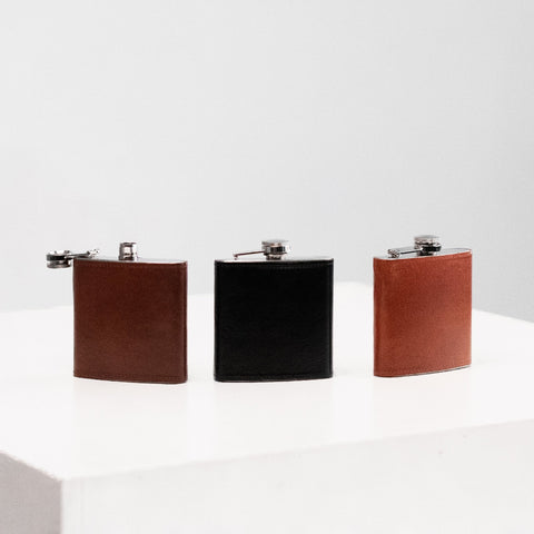 1. Papillon Hip Flask No. 21 in brown and black leather, displayed on a white surface