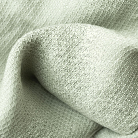 3. Close-up of sage green waffle linen fabric texture showing fine weave