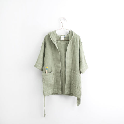 2. Kids sage green linen bathrobe with hood and pockets hanging on white background
