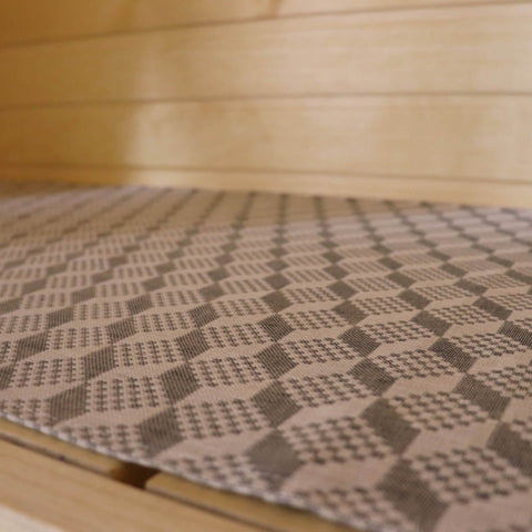 2. Close-up of LOKO sauna seating pad showing detailed Viru County mitten pattern on linen-cotton fabric