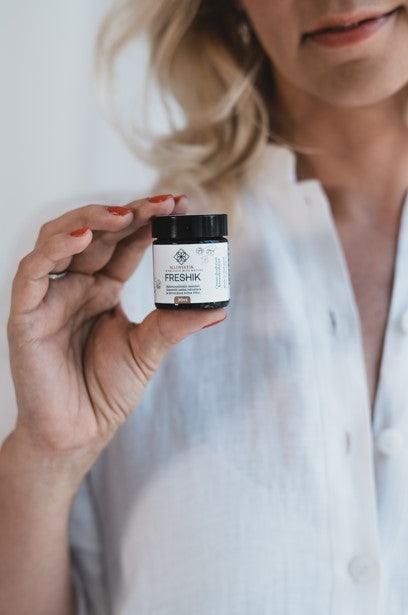1. Woman holding MaiWistik FRESHIK Chamomile Cream Deodorant 30ml, showcasing product size and packaging