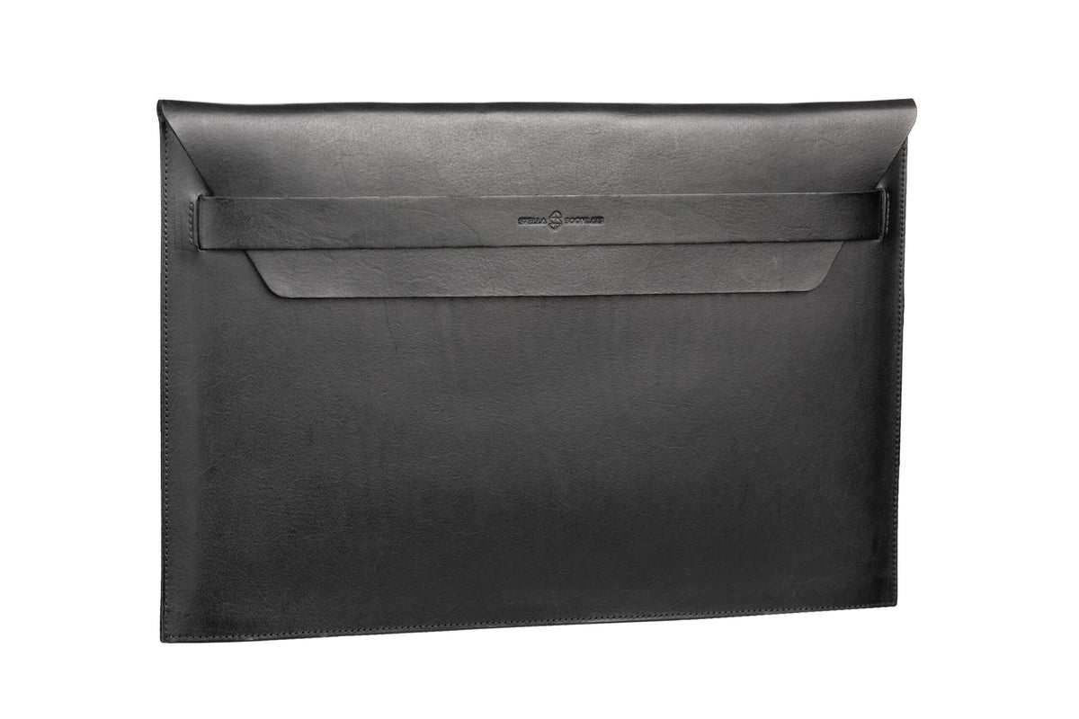 4. Black Stella Soomlais leather laptop sleeve with flap shown in studio setting highlighting sleek design