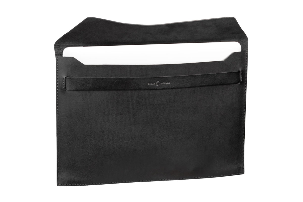 5. Open black Stella Soomlais leather laptop sleeve with flap in studio setting showing interior space