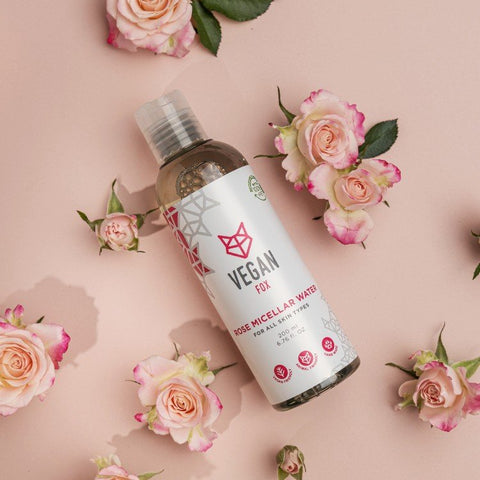2. Vegan Fox Rose Micellar Water bottle surrounded by pink roses on a pastel background