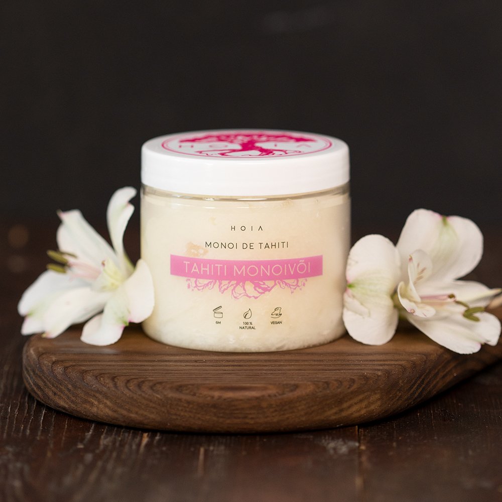 4. HOIA homespa Monoi de Tahiti Body Butter jar on wooden board with white flowers