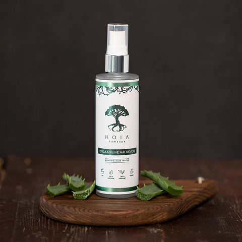 1. HOIA homespa Organic Aloe Water 100ML bottle on wooden board with aloe leaves, highlighting natural skincare benefits