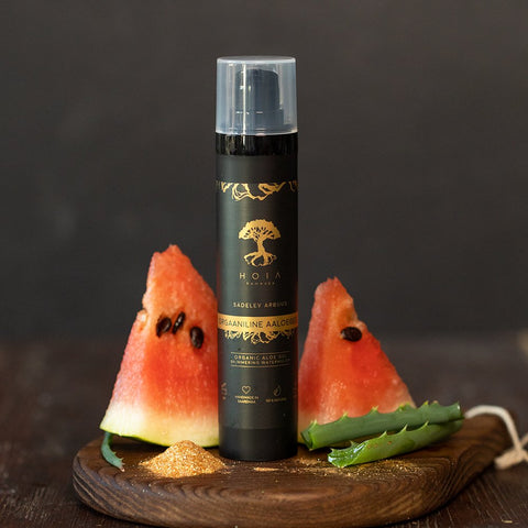 1. HOIA homespa Organic Aloe Gel Shimmering Watermelon bottle displayed with fresh watermelon slices and aloe leaf on wooden board