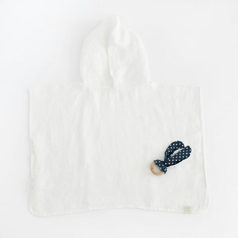 4. Flat lay of white linen waffle poncho with hood and polka dot accessory