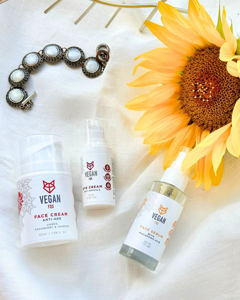 2. Vegan Fox Anti-Age Face Care Set including face cream, eye cream, and serum with sunflower and jewelry in a lifestyle arrangement