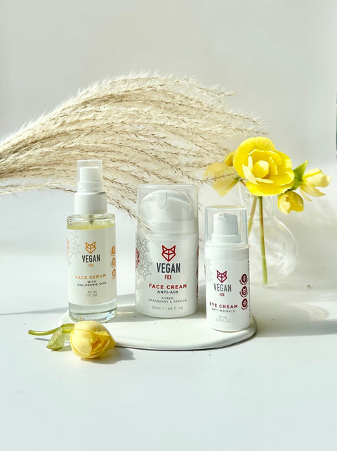 1. Vegan Fox Anti-Age Face Care Set with face cream, eye cream, and serum displayed with yellow flowers in a lifestyle setting