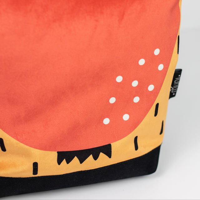 7. Detailed view of Muni apple backpack, showcasing colorful apple motif and craftsmanship