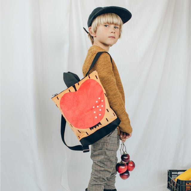 4. Studio image of Muni apple backpack for kids, featuring bright apple motif and sturdy design