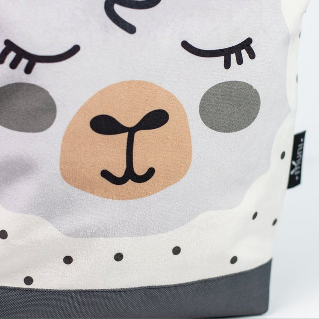 3. Close-up of Muni sheep backpack design, highlighting the cute sheep face and velvet texture