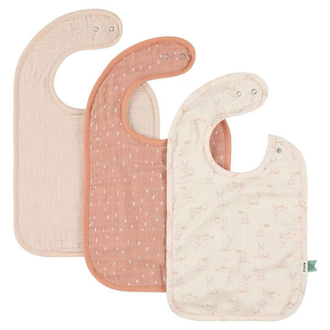 1. Set of three Trixie Baby bibs in Rosy Rabbit design featuring one patterned and two solid colors, made from organic cotton with adjustable snaps
