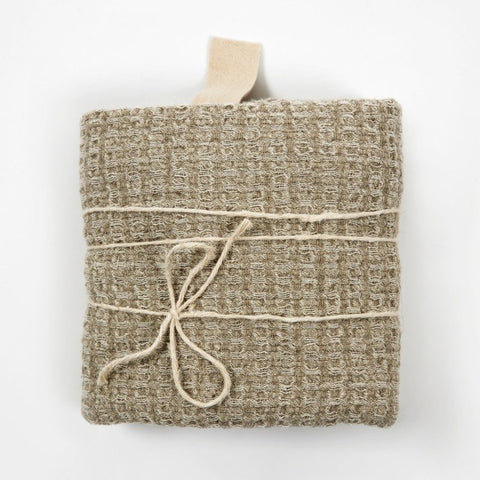 1. Folded grey textured linen towel with cotton hanger and tied with string on white background