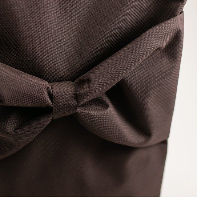 8. Close-up of MUNI brown backpack highlighting large bow detail