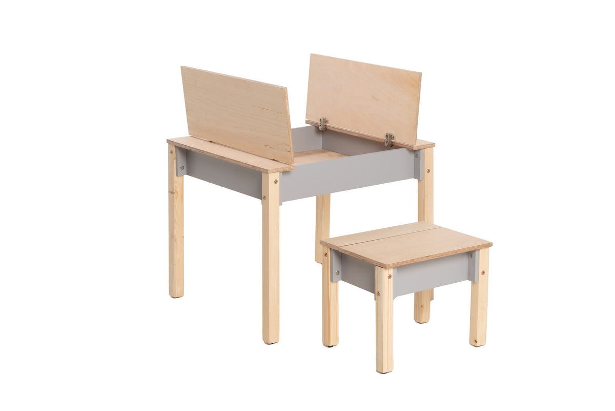2. Studio shot of children's smart storage table and chair set in light wood and grey, showing open storage compartments