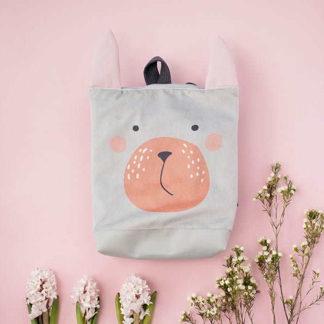 7. Muni Bunny kids backpack in studio with miniature trees, emphasizing playful theme