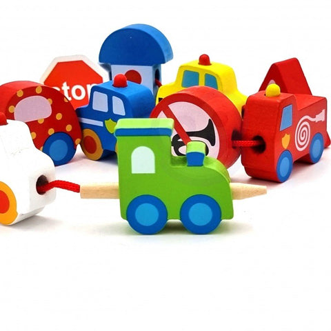 3. Assorted colorful wooden vehicle blocks including a green tractor and red fire truck with threading string