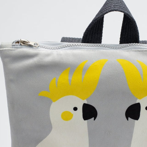 5. Close-up of Muni Cockatoo backpack, focusing on cockatoo design and zipper detail