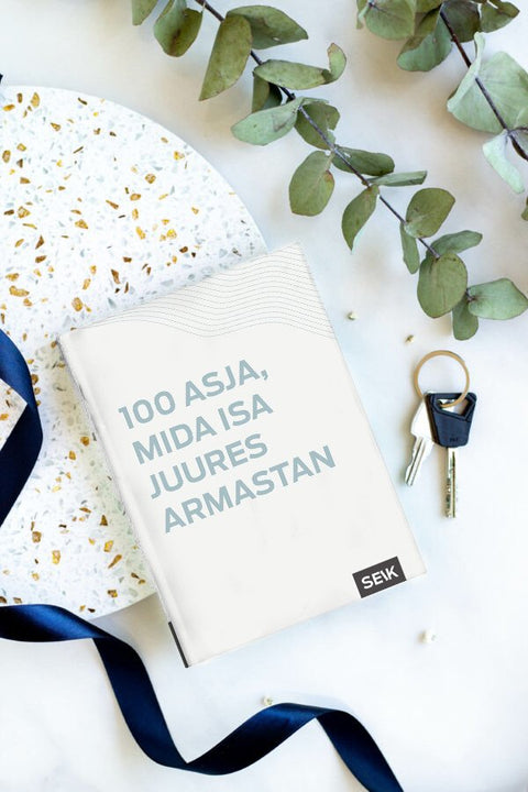 1. SEIK '100 ASJA, MIDA ISA JUURES ARMASTAN' book on marble surface with keys and ribbon, perfect gift for dads