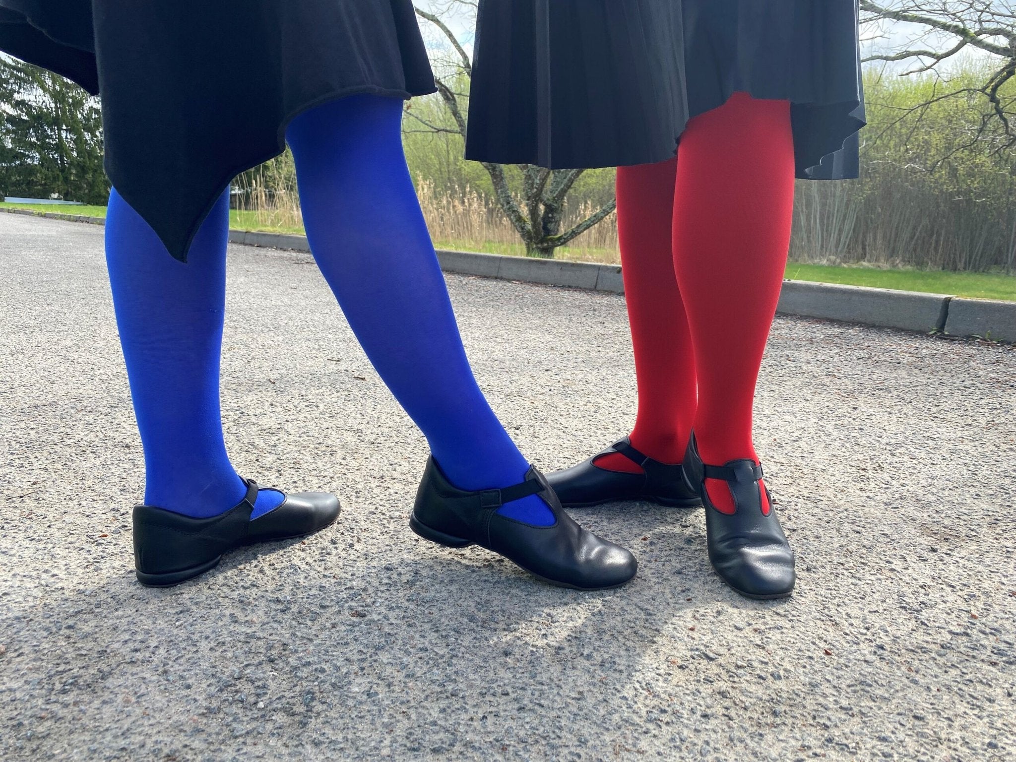 1. Women's black Kergatsi dance shoes by OmaKing worn with colorful tights, shown outdoors