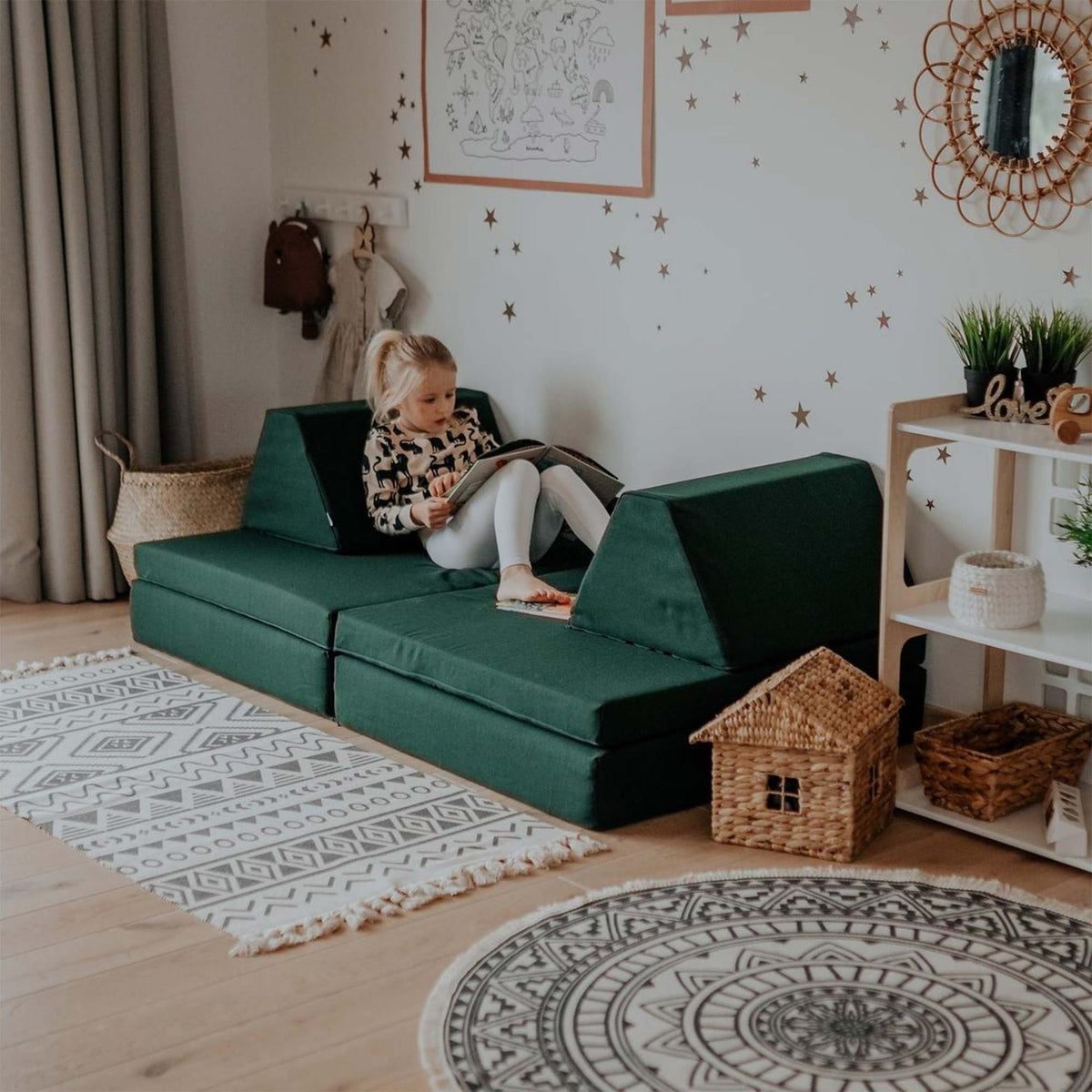 2. Child reading on Monboxy deep green play mattress set in a cozy room