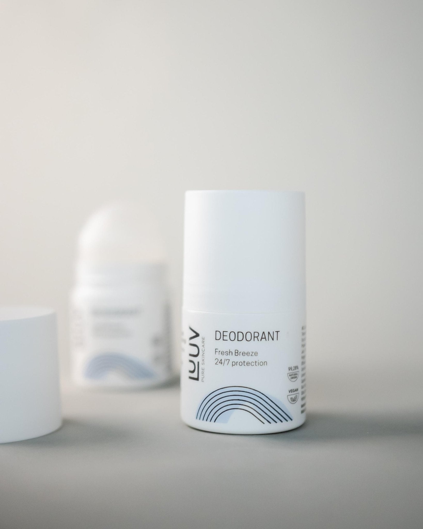 1. LUUV Fresh deodorant bottle with Fresh Breeze 24/7 protection label on a light background, featuring minimalist design and blue wave graphic