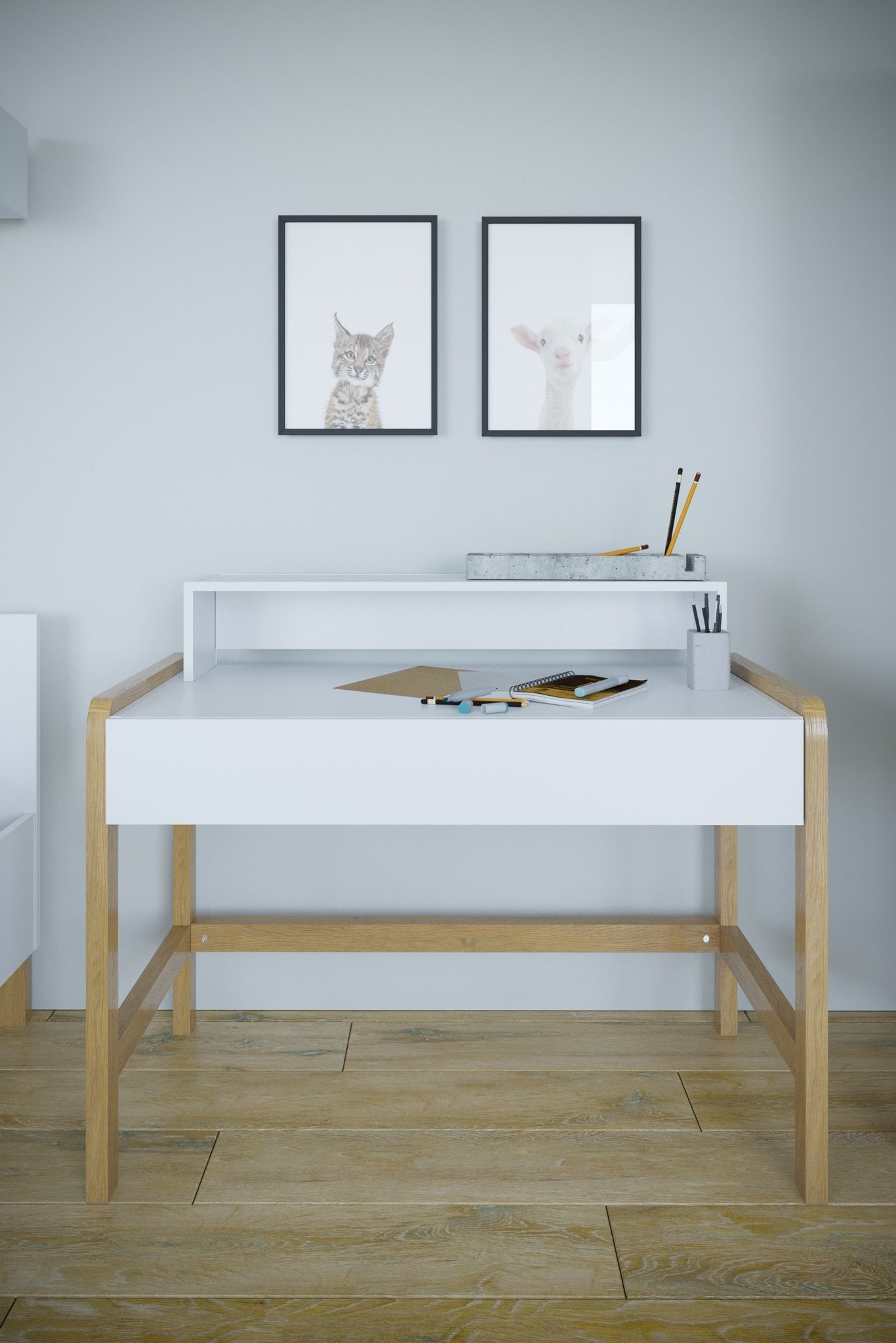 1. Scandinavian-style children's desk with white tabletop and oak legs in a room setting with wall art and stationery