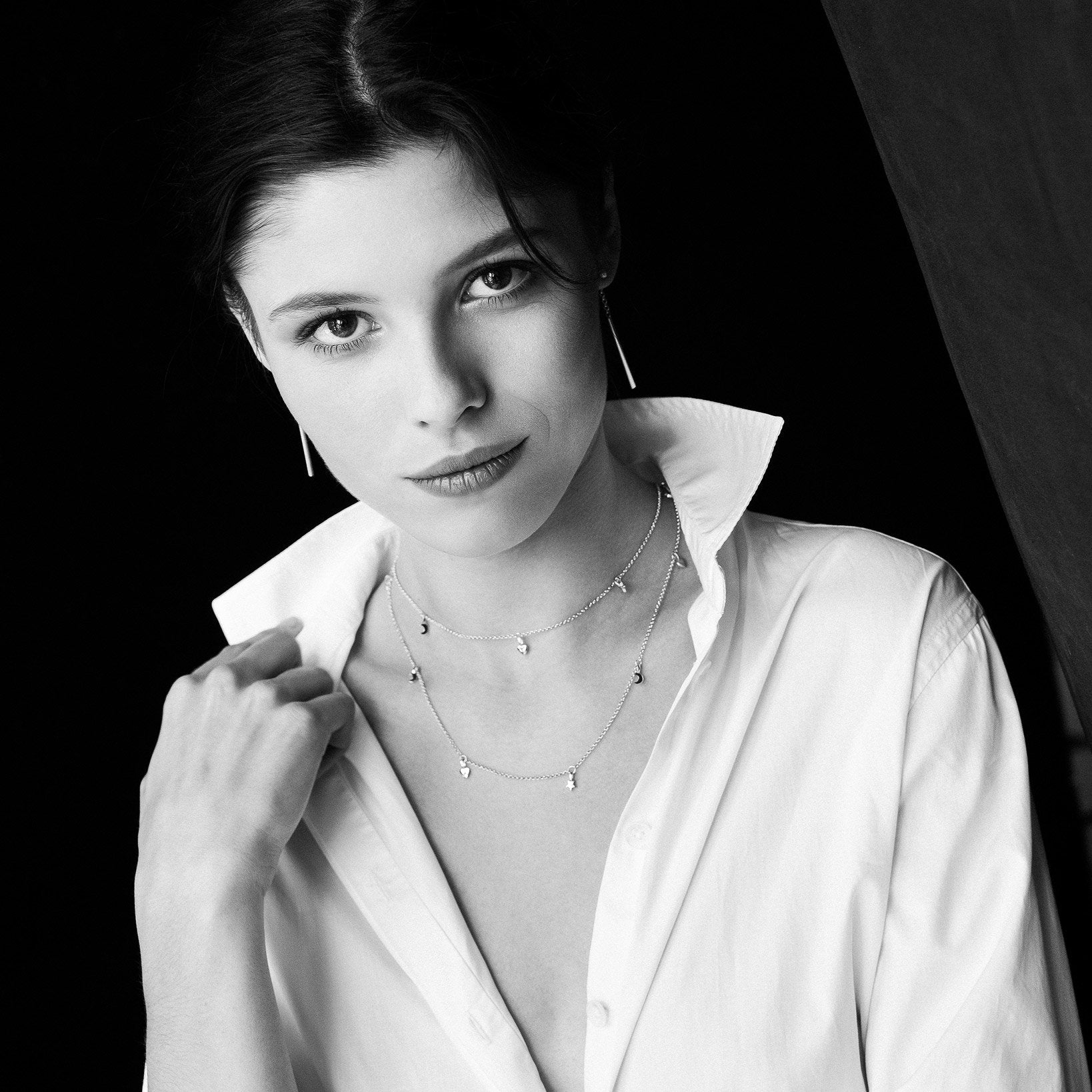 1. Woman wearing MyaMoon Dreamer Choker in black and white, showcasing elegant design and layering style