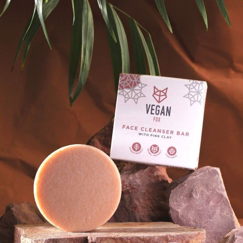 3. Vegan Fox Face Cleanser Bar with Pink Clay on rocks, packaging visible