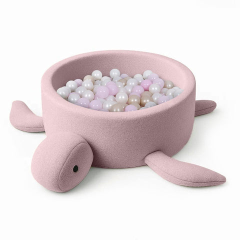 2. Turtle-shaped baby ball pit in raspberry glaze pink boucle fabric filled with pastel balls, shown on a white background