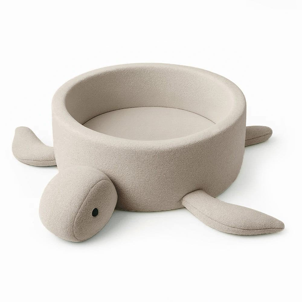 1. Beige turtle-shaped foam baby ball pit with boucle fabric and soft fins, shown empty on a white background