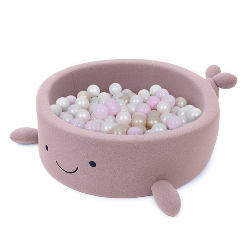 2. Whale-shaped baby ball pit in raspberry glaze pink boucle filled with pastel-colored balls