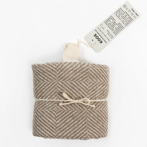 5. Beige linen towel with checkered fishbone pattern, folded and tied with string, featuring KOOSdisain tag