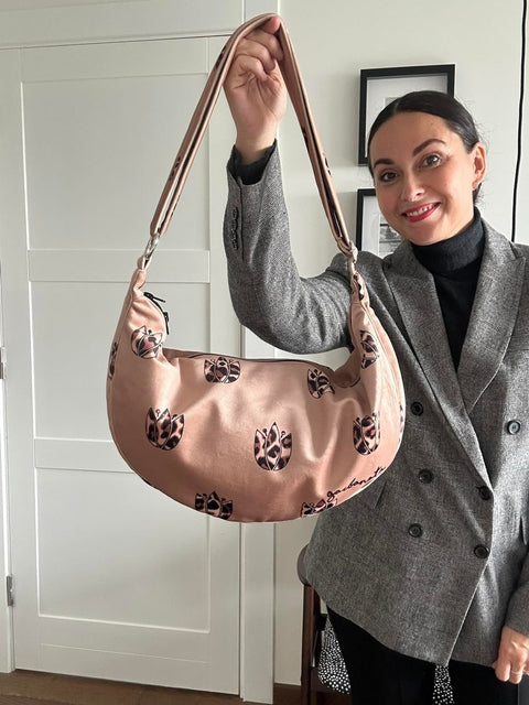 5. Woman holding Garbanota Hobo Bag in Brown Leopard Tulips, shown in indoor setting