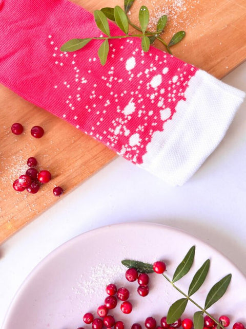 2. Close-up of SEIK cranberry Long Drink Socks with white pattern, surrounded by cranberries