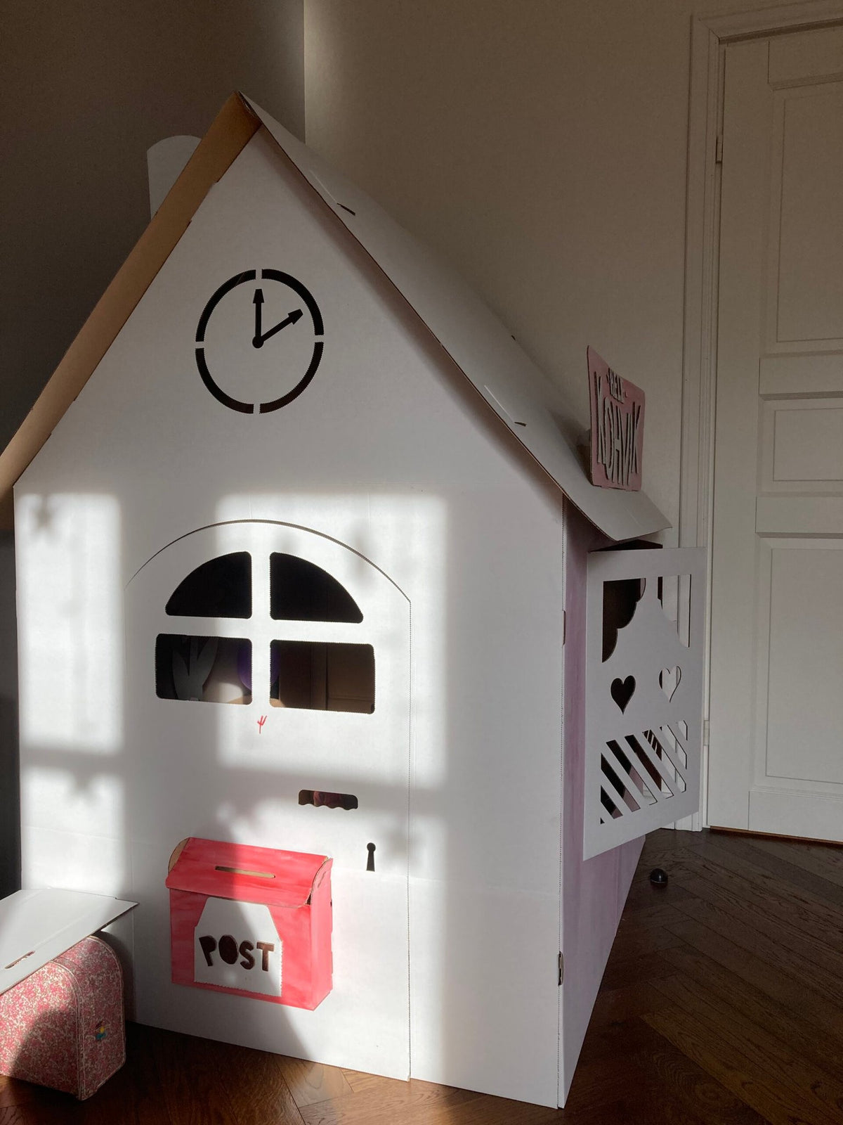 3. SEIK cardboard house for kids styled as a post office with red mailbox, shown indoors