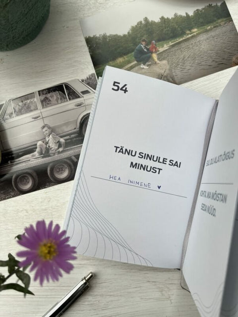 2. Open page of SEIK '100 ASJA, MIDA ISA JUURES ARMASTAN' book with personal reflection prompts, surrounded by nostalgic photos